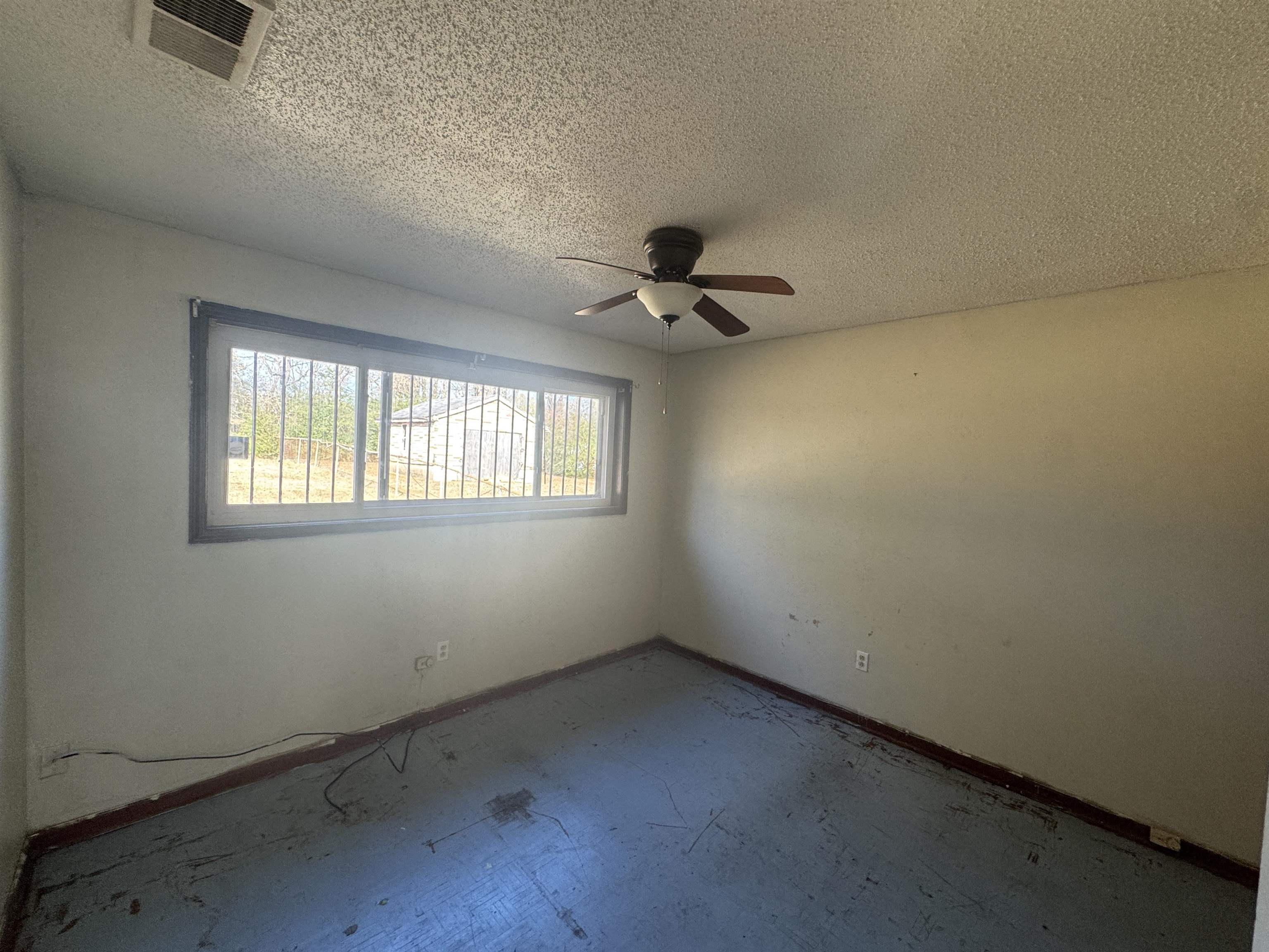 256 Delta Road Memphis, TN 38109 - Photo 22 of 22 Unfurnished room featuring a textured ceiling and a ceiling fan