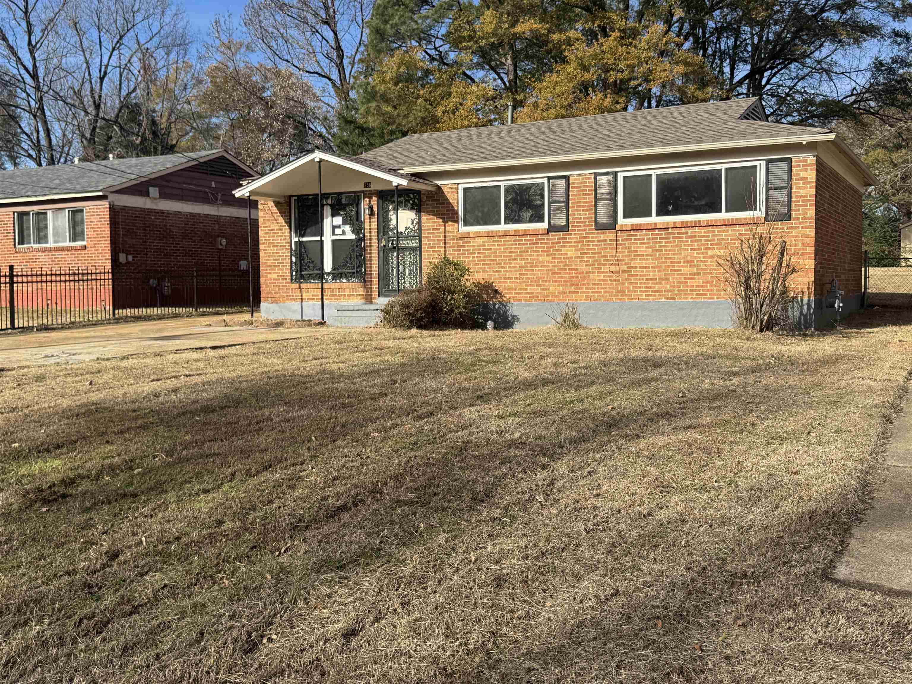 256 Delta Road Memphis, TN 38109 - Photo 6 of 22 Ranch-style house featuring brick siding and roof with shingles