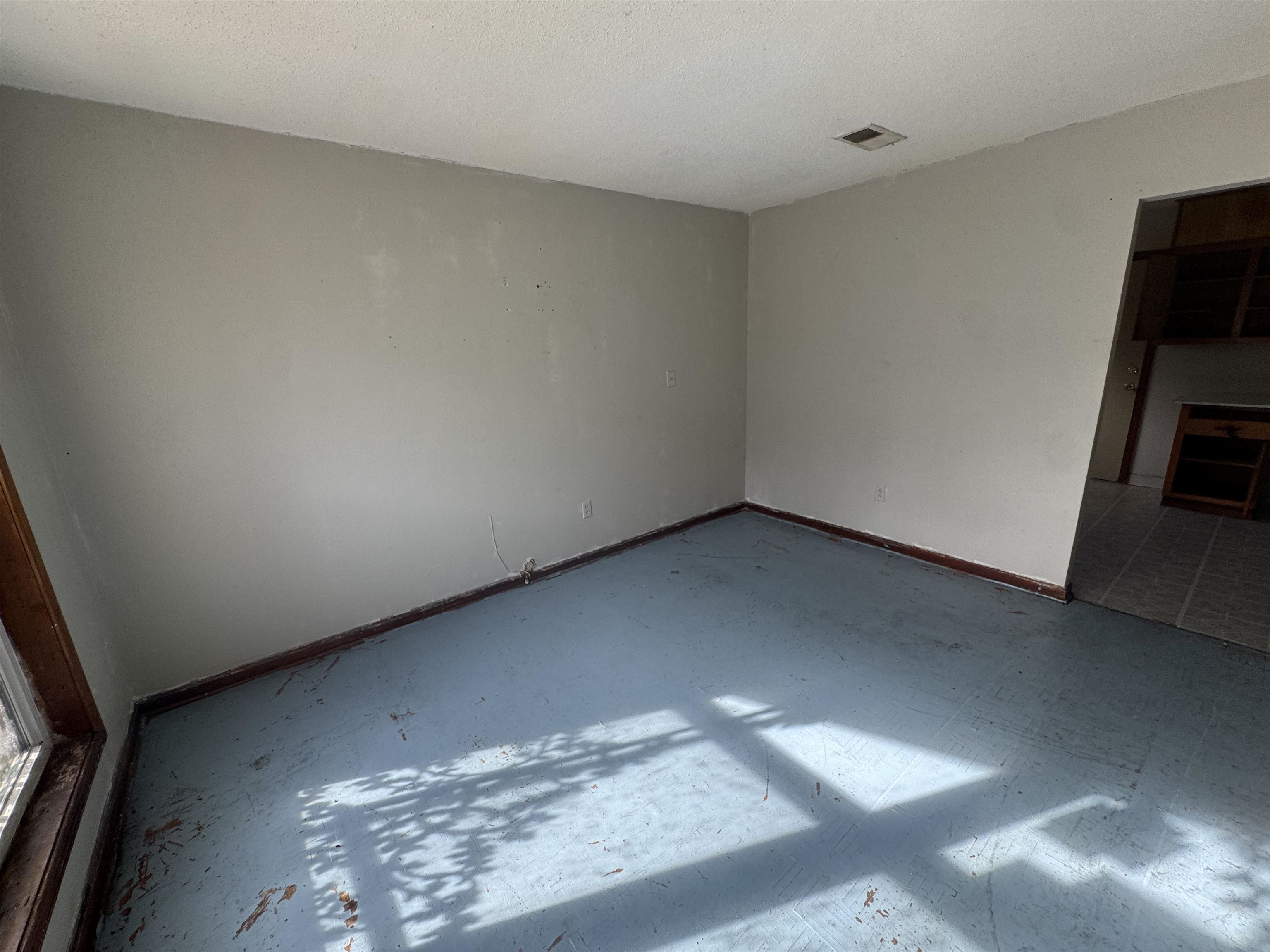 256 Delta Road Memphis, TN 38109 - Photo 9 of 22 Spare room featuring a textured ceiling and baseboards