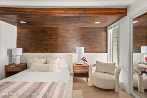 a bedroom with a bed and a lamp