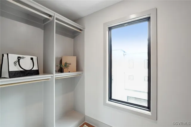 a bathroom with a granite countertop sink a toilet a mirror and shower