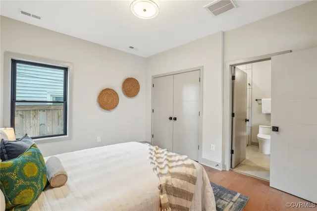 a bedroom with a bed and cabinets