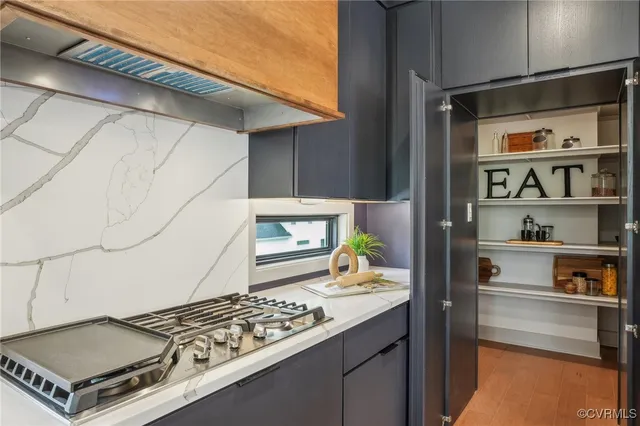 a kitchen with a stove and a refrigerator