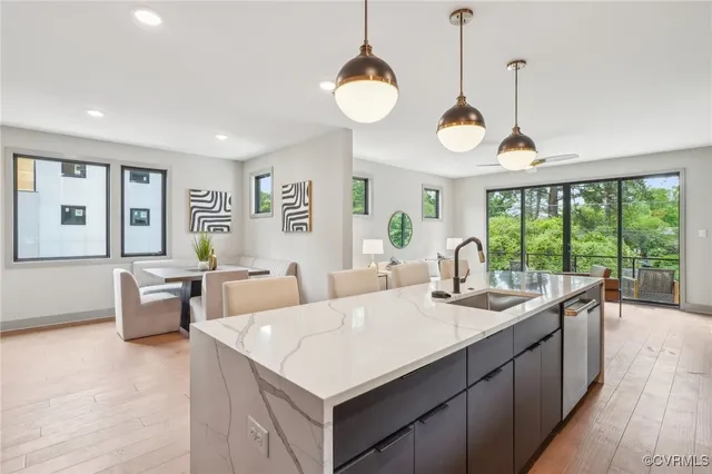 a living room with furniture a large window and a chandelier