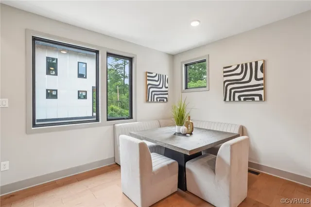 a view of a workspace with furniture and window