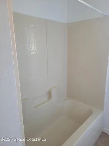 a view of a room with furniture and window