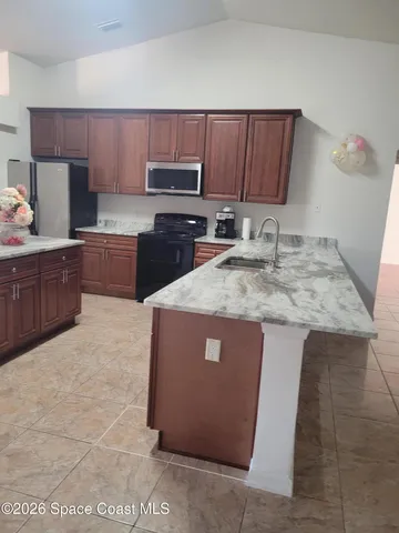 a bathroom with a tub a sink and a large mirror