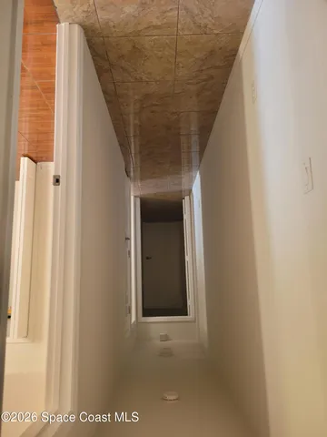 a room with wooden floor and a window