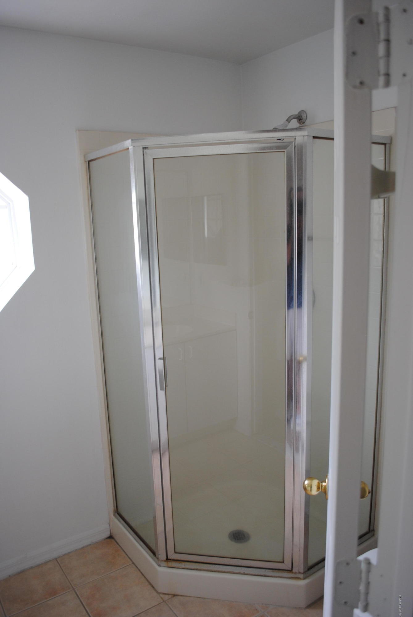 161 Tucson Road Southwest Palm Bay, FL 32908 - Photo 11 of 31 a bathroom with a glass shower door