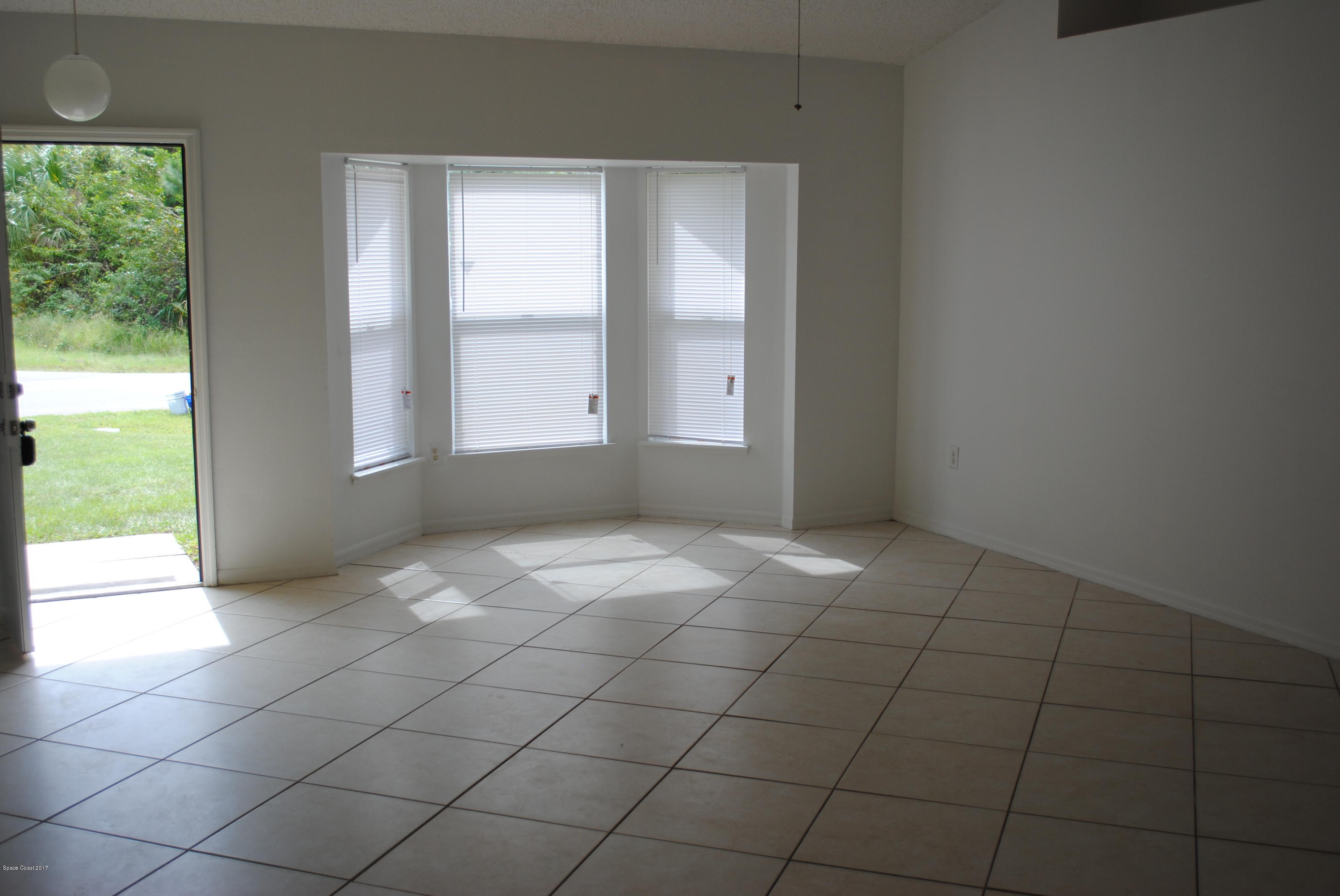 161 Tucson Road Southwest Palm Bay, FL 32908 - Photo 3 of 31 an empty room with windows