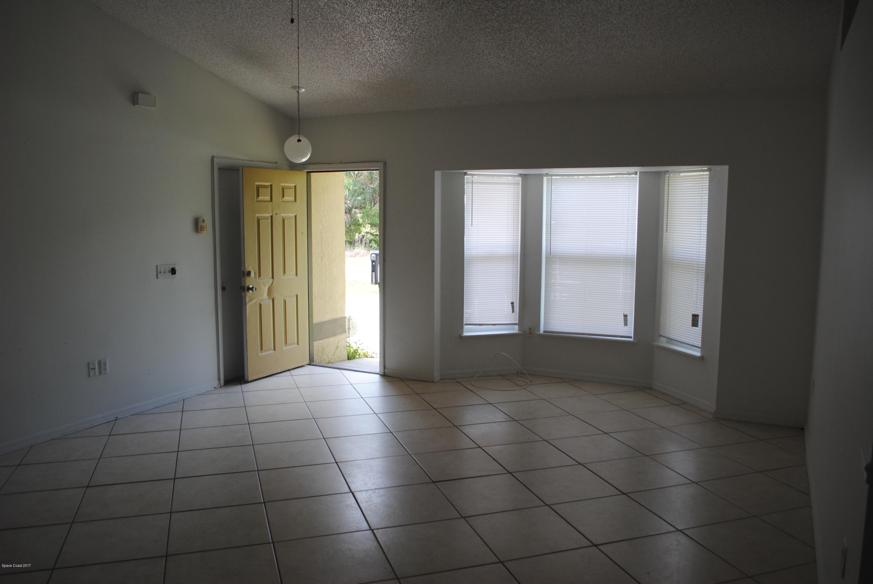 161 Tucson Road Southwest Palm Bay, FL 32908 - Photo 4 of 31 a view of an empty room with window and bathroom