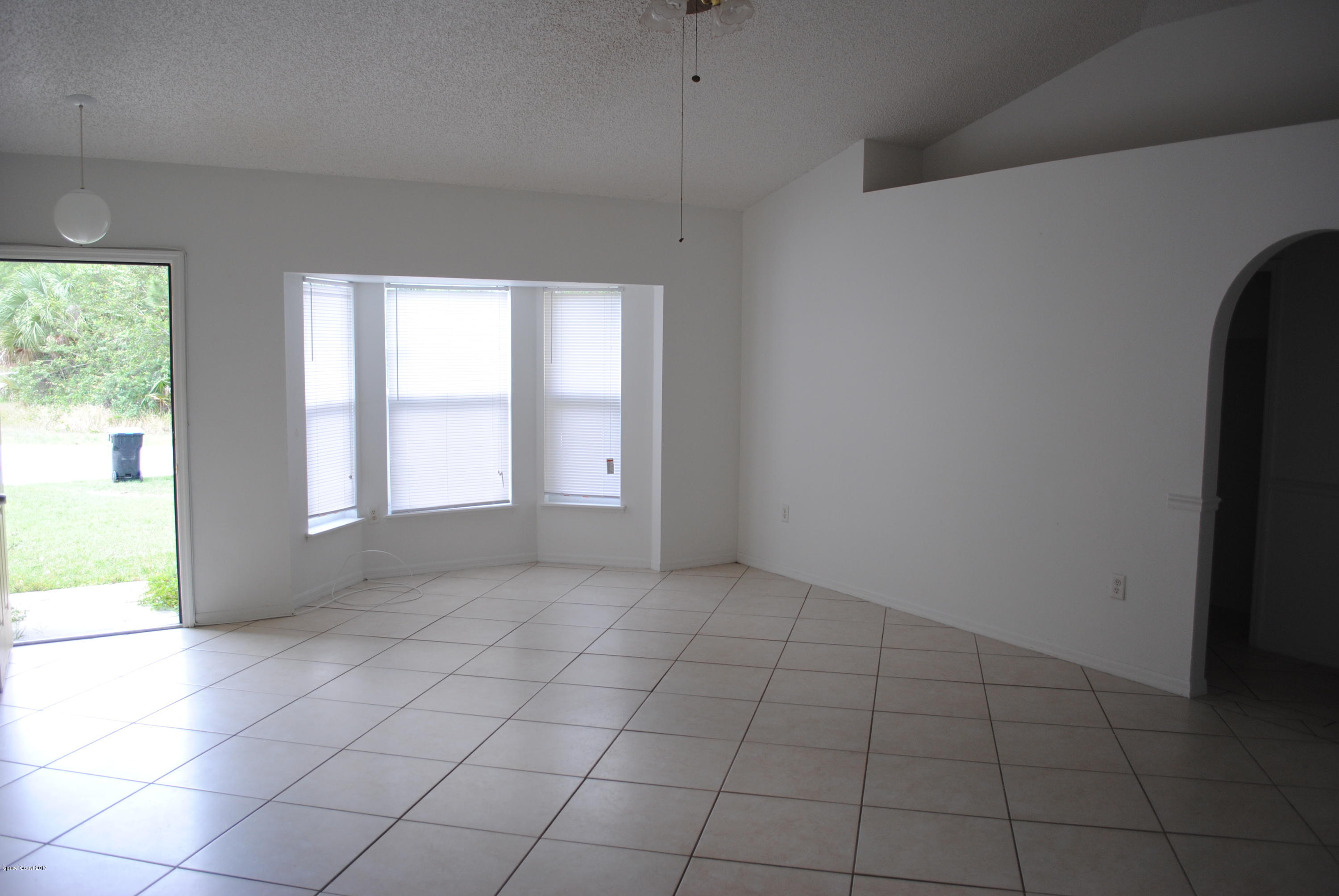 161 Tucson Road Southwest Palm Bay, FL 32908 - Photo 5 of 31 an empty room with windows