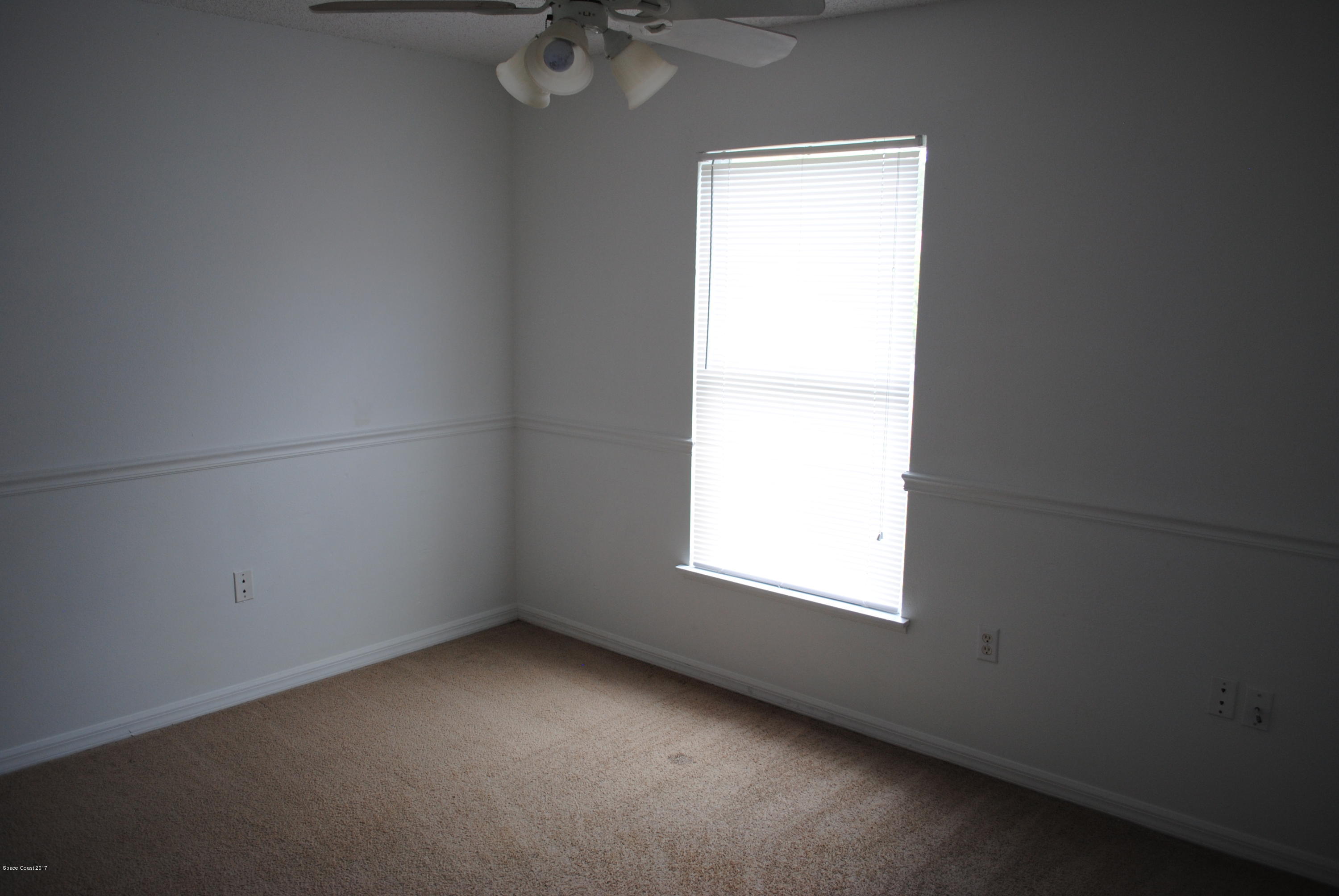 161 Tucson Road Southwest Palm Bay, FL 32908 - Photo 6 of 31 an empty room with a window