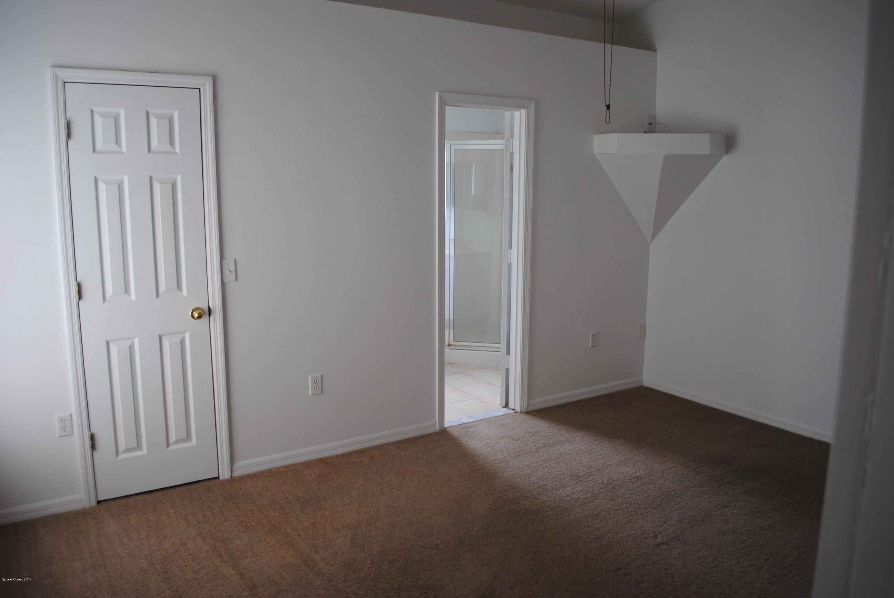 161 Tucson Road Southwest Palm Bay, FL 32908 - Photo 7 of 31 an empty room with windows