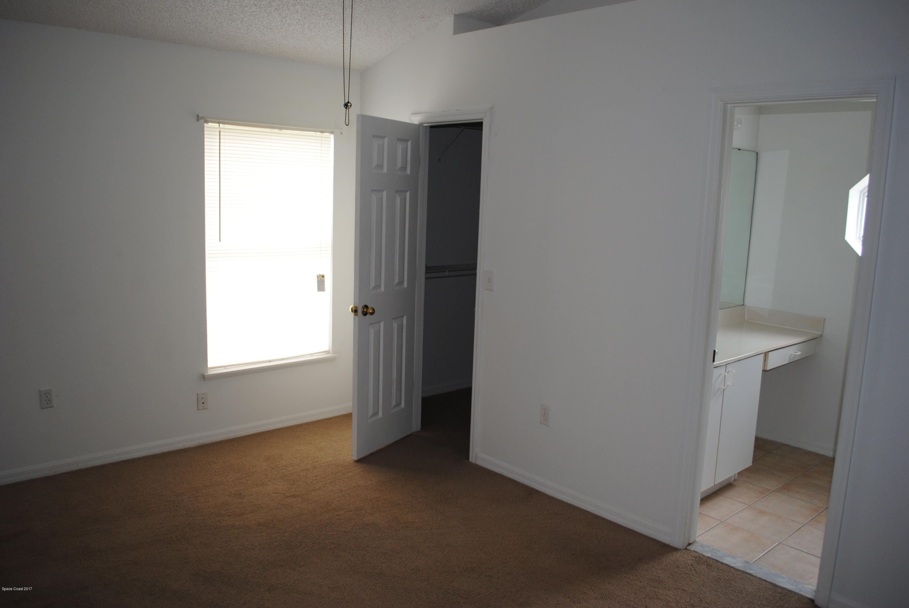 161 Tucson Road Southwest Palm Bay, FL 32908 - Photo 8 of 31 a view of an empty room with a window