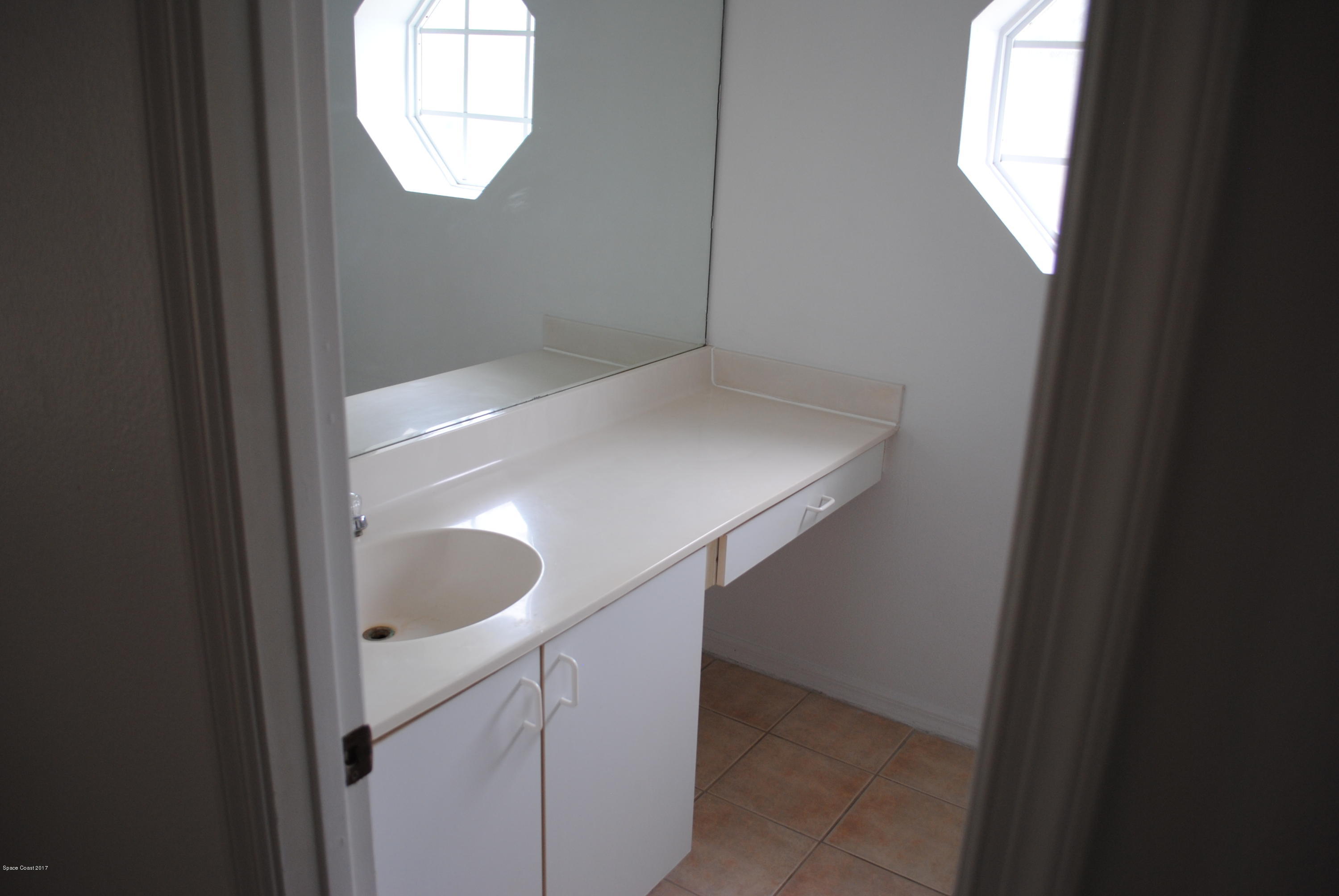 161 Tucson Road Southwest Palm Bay, FL 32908 - Photo 10 of 31 a bathroom with a sink and mirror