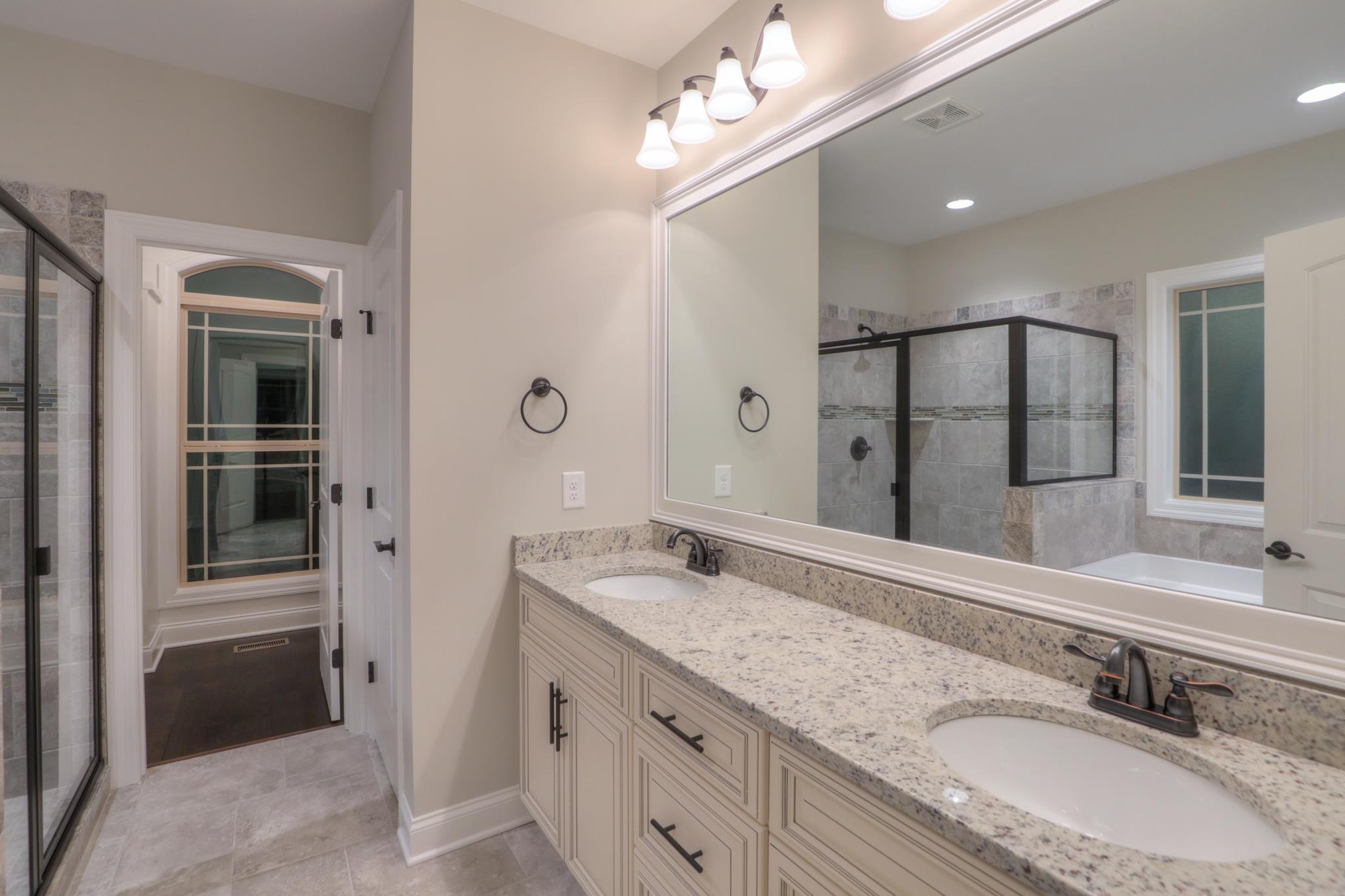 2211 Cairo Bend Road Lebanon, TN 37087 - Photo 19 of 29 a bathroom with a granite countertop double vanity sink and mirror