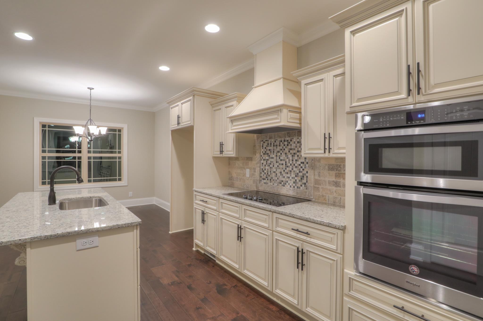 2211 Cairo Bend Road Lebanon, TN 37087 - Photo 7 of 29 a kitchen with stainless steel appliances granite countertop a stove and a sink
