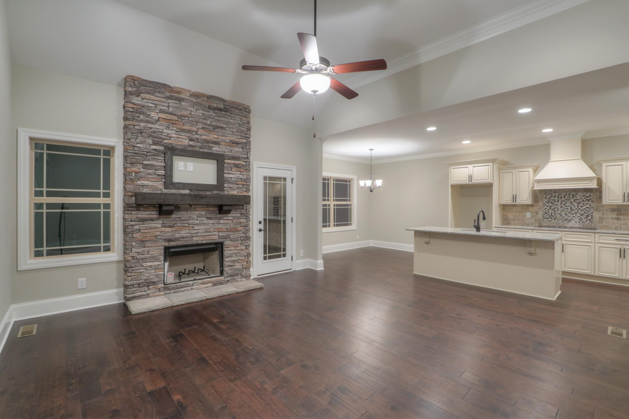 2211 Cairo Bend Road Lebanon, TN 37087 - Photo 9 of 29 a view of a kitchen with a stove wooden cabinets and a fireplace