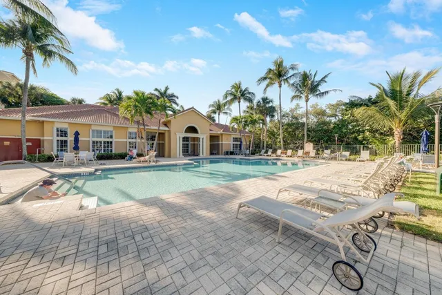 a swimming pool with outdoor seating and yard