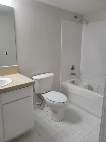 a white toilet sitting next to a bathroom sink