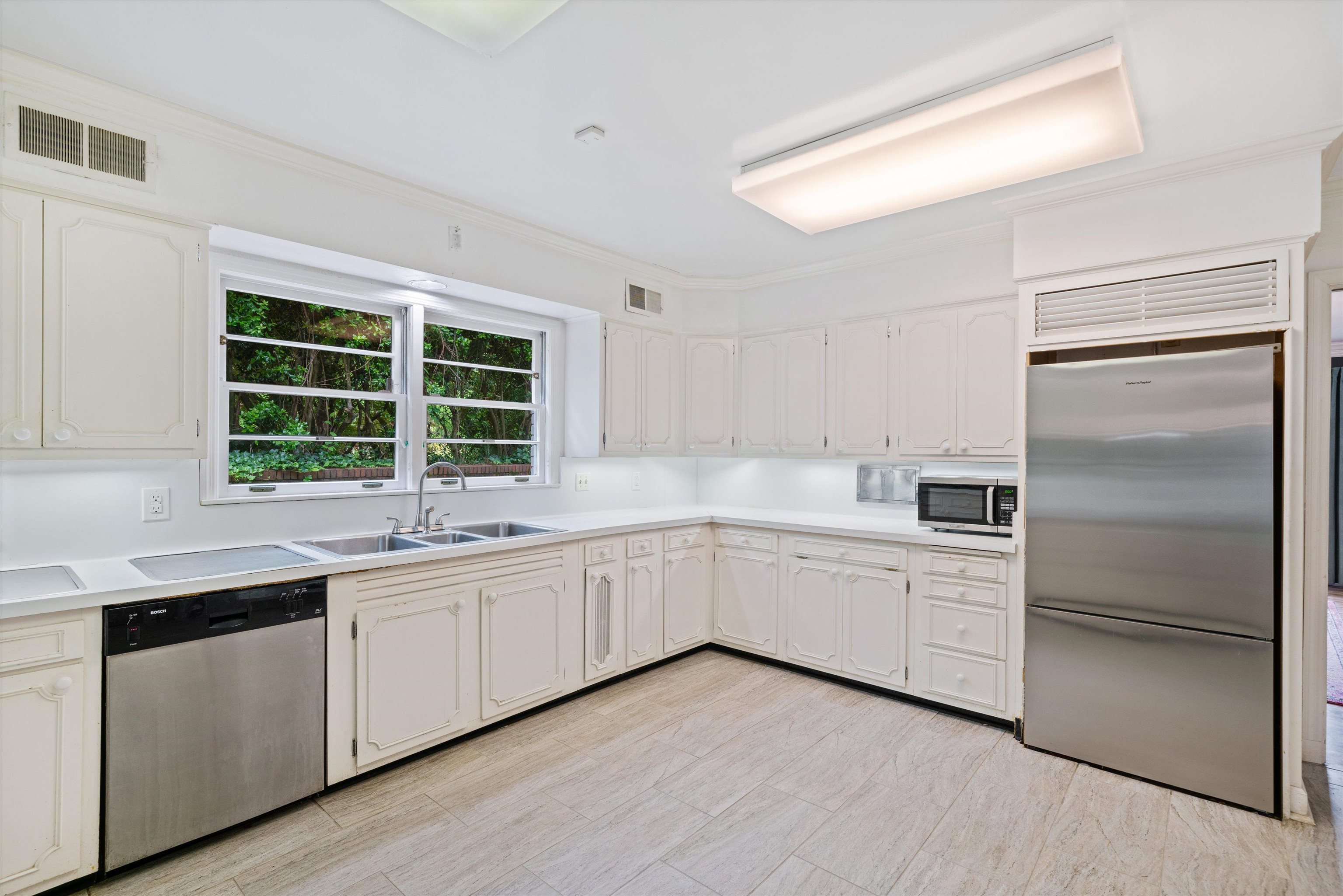 4391 Barfield Road Memphis, TN 38117 - Photo 6 of 25 a kitchen with white cabinets sink and window