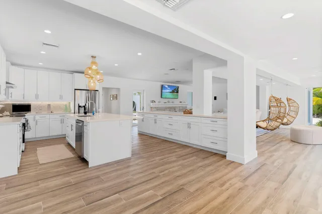 a bathroom with a granite countertop toilet sink and mirror