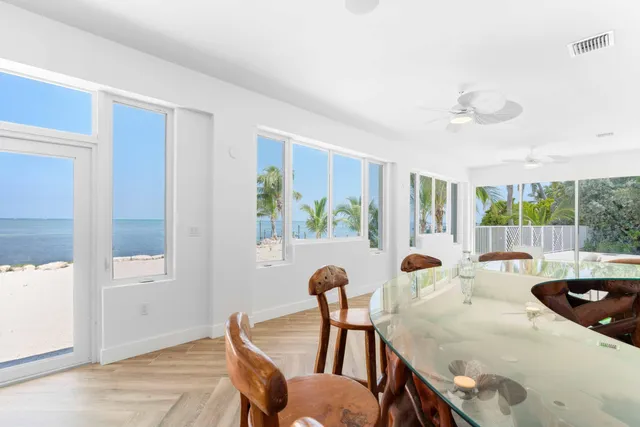 a bathroom with a granite countertop toilet sink and mirror