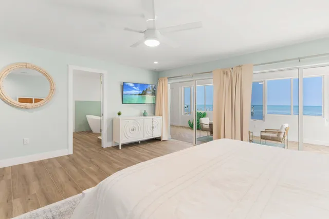 a bedroom with a large bed and a large window