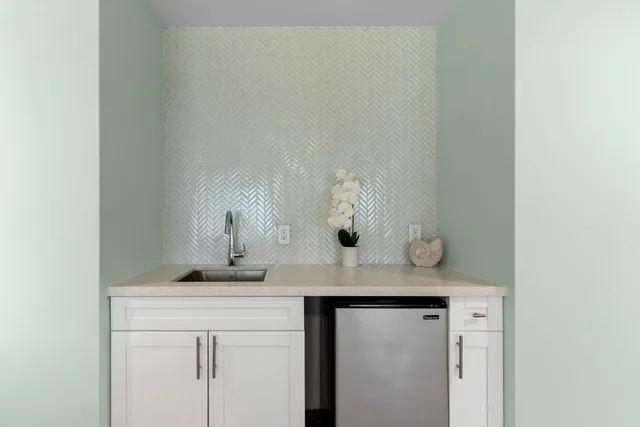 a bathroom with a granite countertop sink a toilet and a mirror