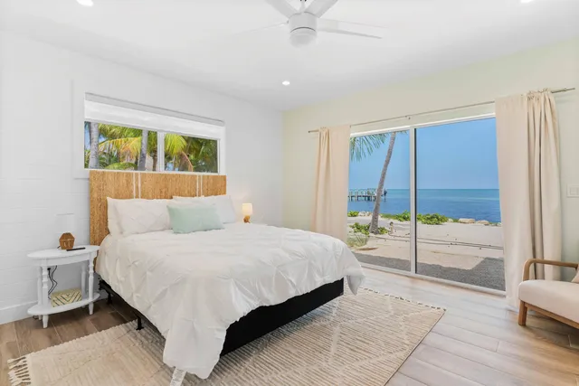 a view of a kitchen with a sink and dishwasher with wooden floor