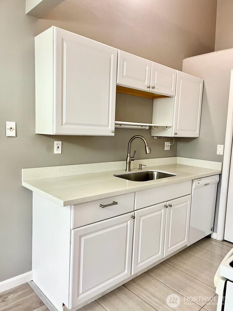 2020 Grant Avenue South, Unit A302 Renton, WA 98055 - Photo 8 of 22 a kitchen with white cabinets sink and white appliances