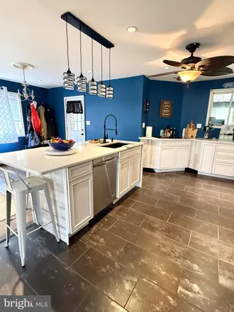a kitchen with stainless steel appliances a sink a counter top space and cabinets