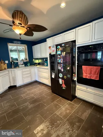a kitchen with stainless steel appliances a stove a refrigerator and cabinets