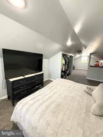 a bedroom with a bed and walk in closet