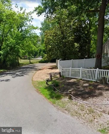 a view of a yard with a wooden fence