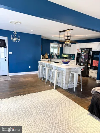 a kitchen with a table chairs and a refrigerator