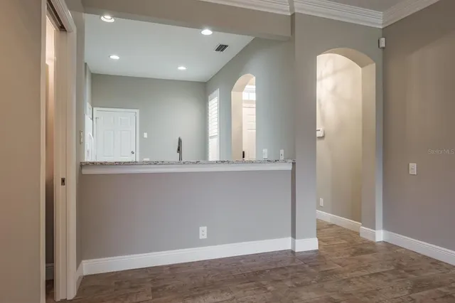 a view of a hallway with granite countertop a mirror