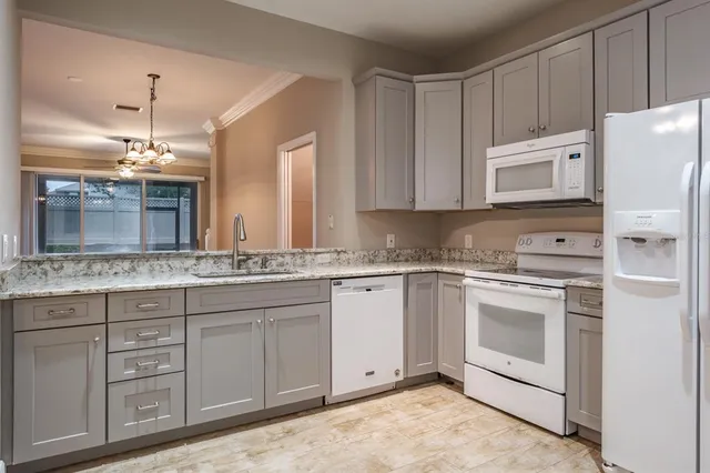 a kitchen with cabinets appliances and a counter space
