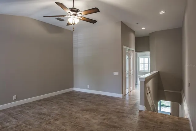 a view of a livingroom with a ceiling fan and window