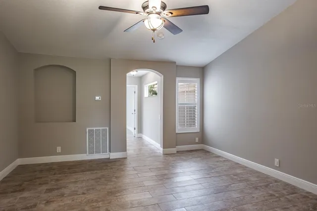 wooden floor in an empty room with a window
