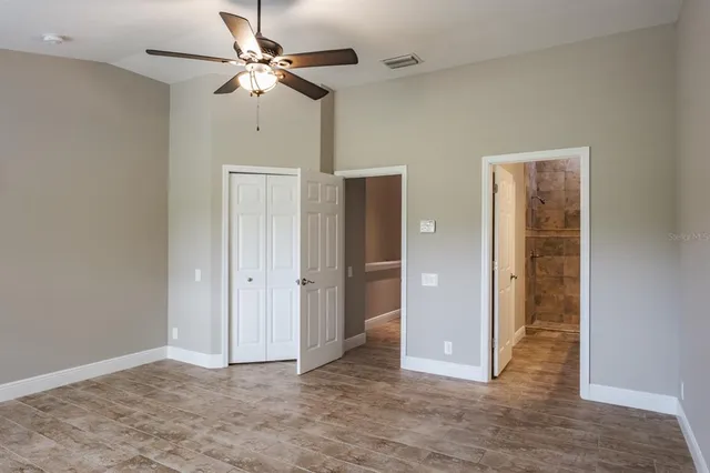 a view of an empty room with a ceiling fan