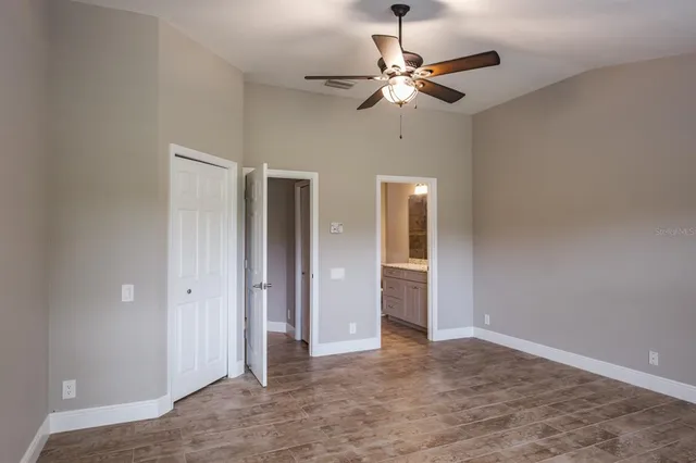 a bathroom with a granite countertop sink a toilet and shower