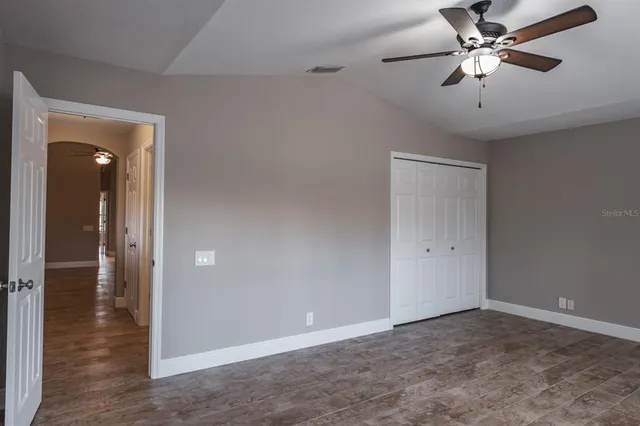 a bathroom with a granite countertop sink toilet a large mirror a bathtub and shower
