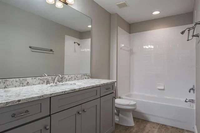 a bathroom with a shower curtain and sink