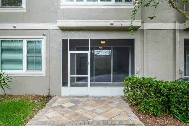 front view of a brick house with a yard