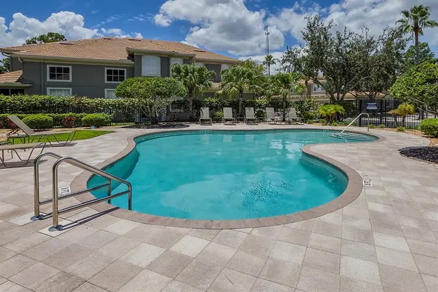 a view of a yard with wooden fence