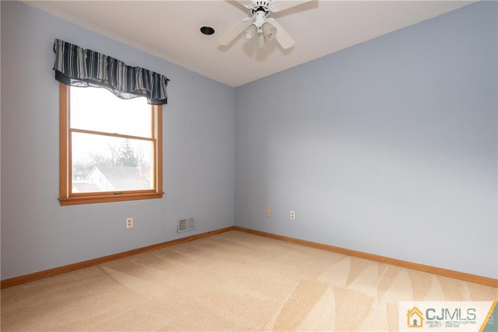 210 Ravine Drive Matawan, NJ 07747 - Photo 17 of 25 a view of an empty room with a window