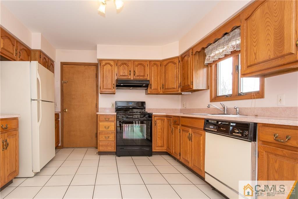 210 Ravine Drive Matawan, NJ 07747 - Photo 8 of 25 a kitchen with stainless steel appliances a refrigerator sink and microwave