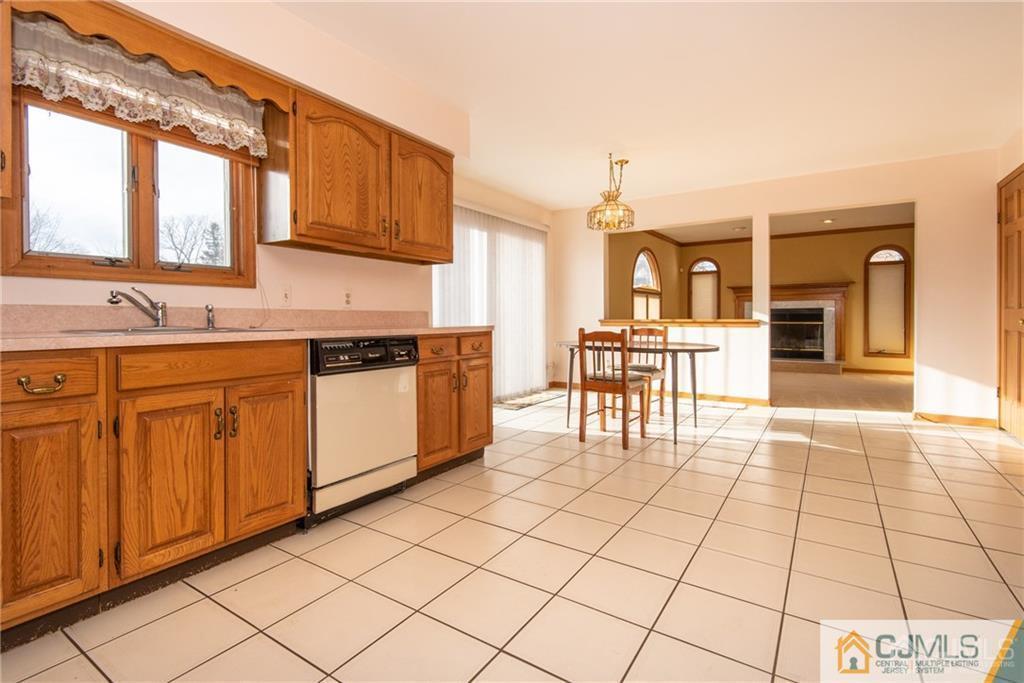 210 Ravine Drive Matawan, NJ 07747 - Photo 9 of 25 a kitchen with stainless steel appliances granite countertop a stove a sink and a microwave